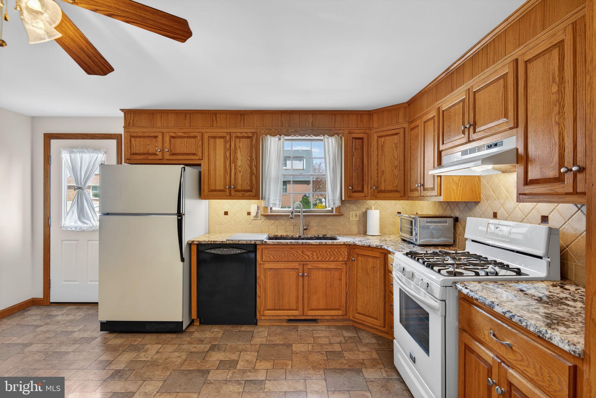 1007 East Walnut Street Lancaster, PA 17602 - Photo 13 of 35 a kitchen with a sink a stove and refrigerator