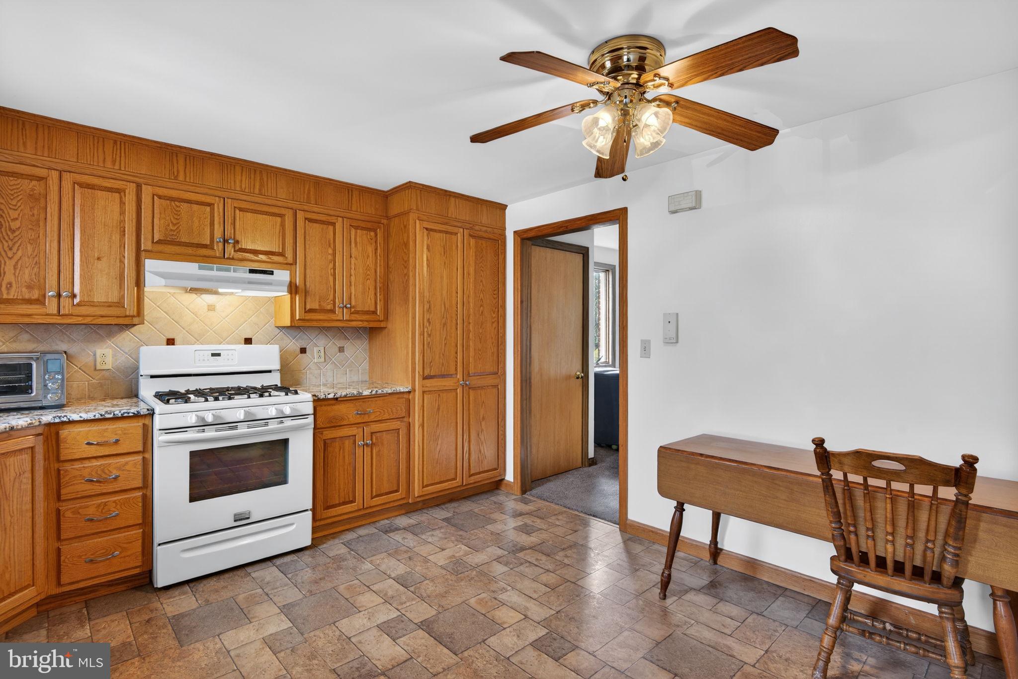 1007 East Walnut Street Lancaster, PA 17602 - Photo 14 of 35 a kitchen with stainless steel appliances a stove a sink cabinets and a dining table