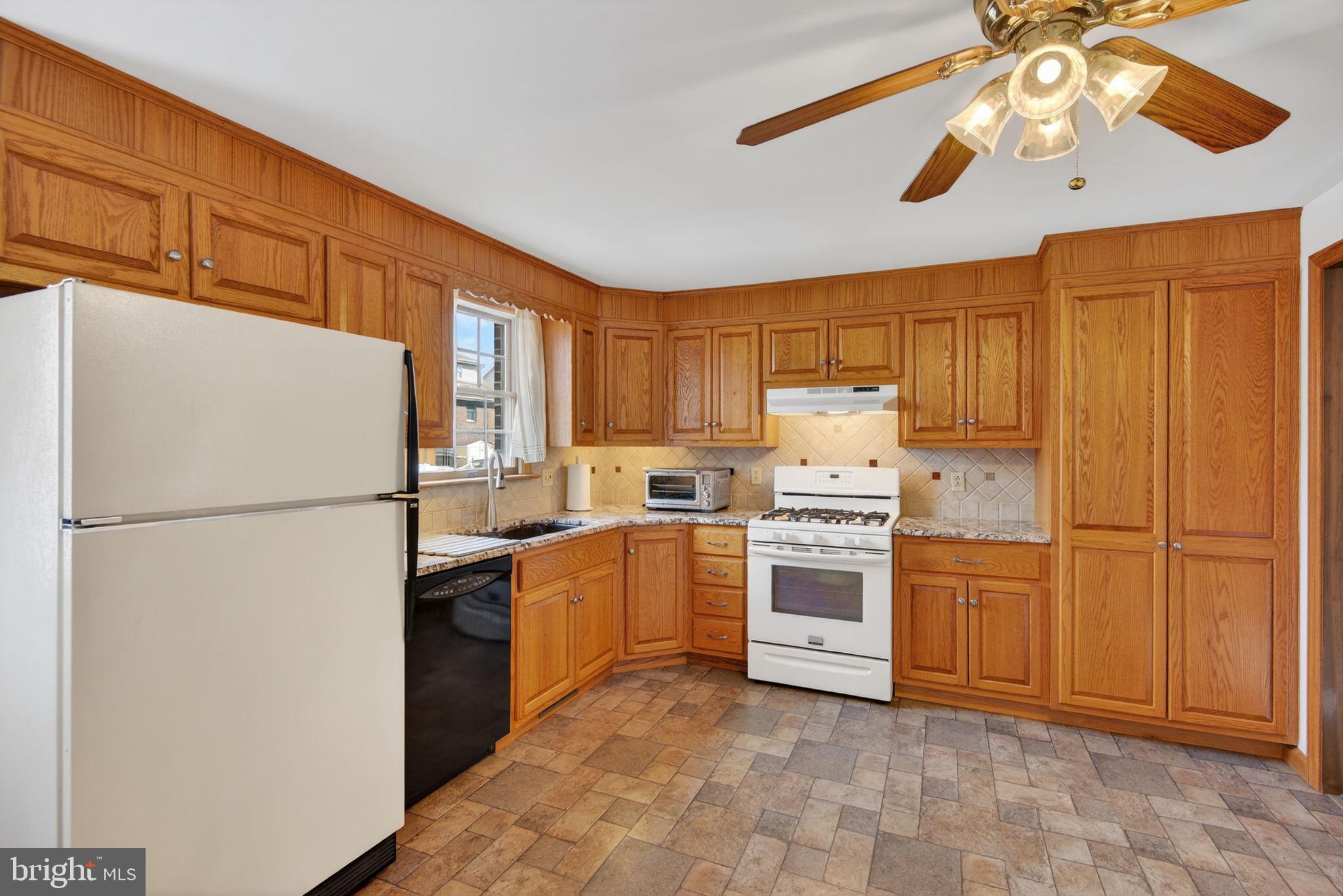 1007 East Walnut Street Lancaster, PA 17602 - Photo 15 of 35 a kitchen with stainless steel appliances granite countertop a refrigerator oven a washer and dryer