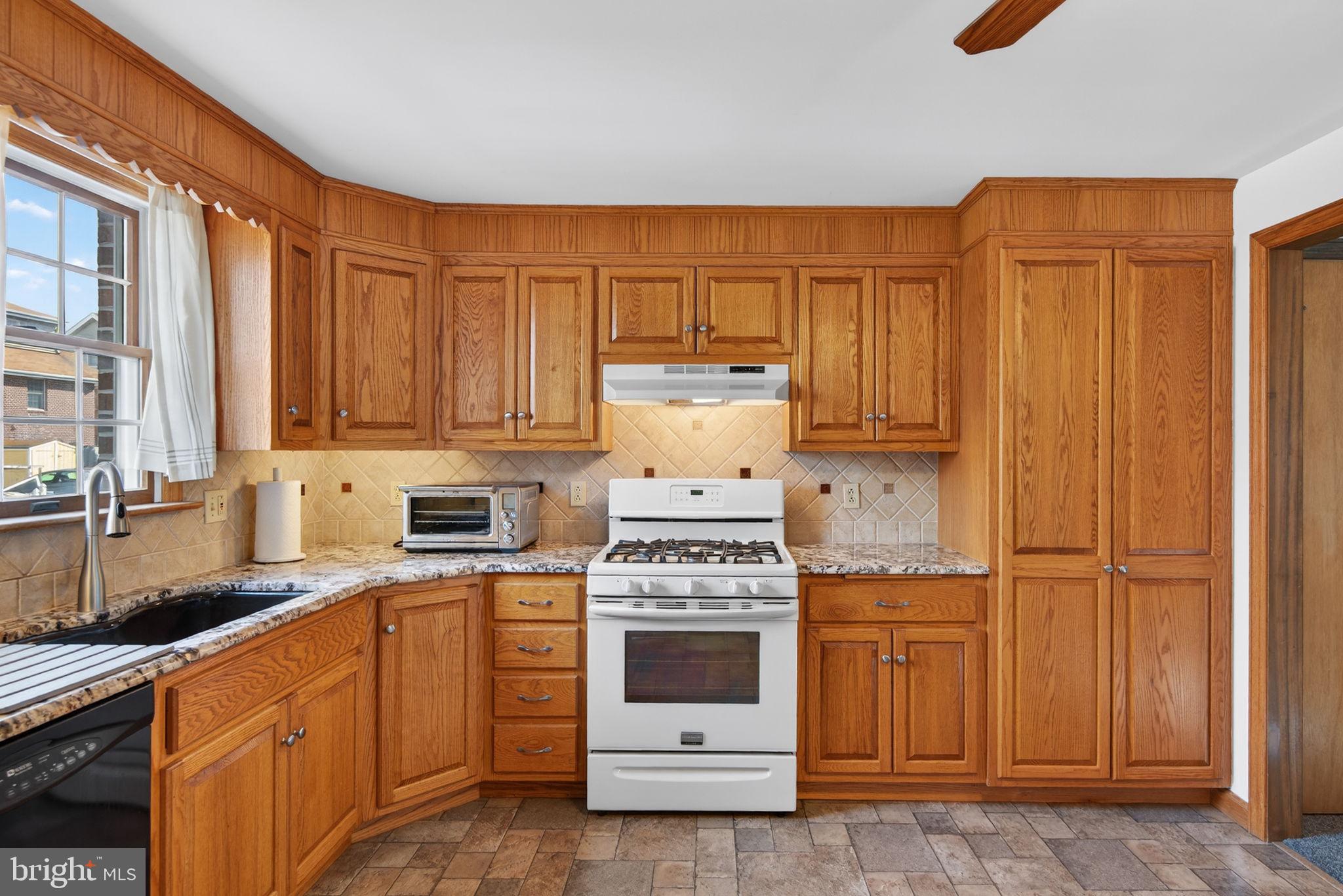 1007 East Walnut Street Lancaster, PA 17602 - Photo 16 of 35 a kitchen with stainless steel appliances granite countertop a stove a refrigerator and cabinets