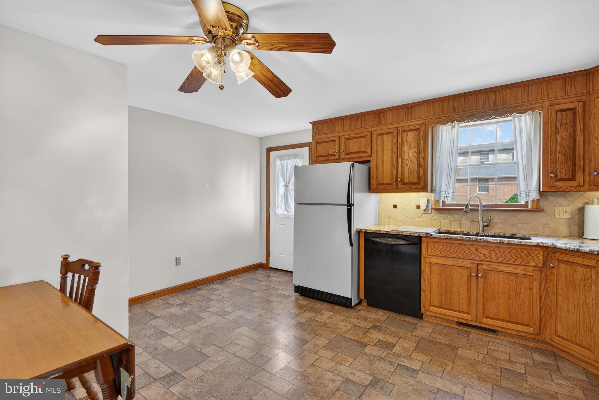 1007 East Walnut Street Lancaster, PA 17602 - Photo 18 of 35 a kitchen with stainless steel appliances granite countertop a refrigerator a sink a stove and island