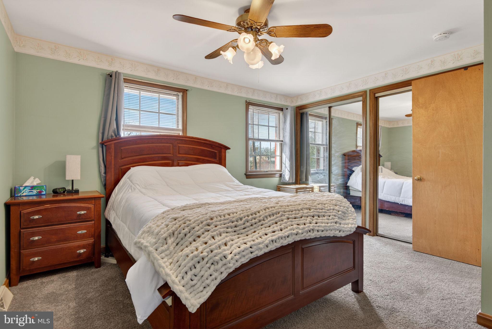 1007 East Walnut Street Lancaster, PA 17602 - Photo 21 of 35 a bedroom with a large bed and a chandelier fan