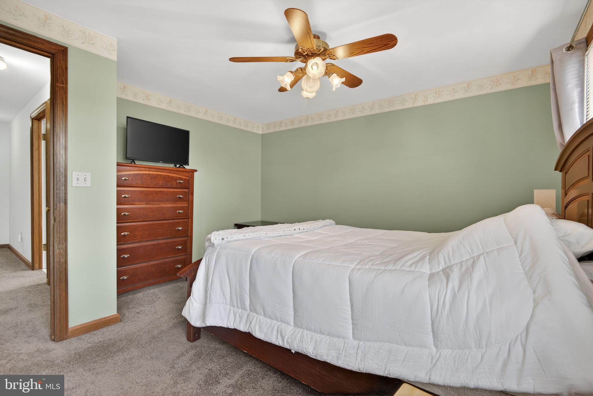 1007 East Walnut Street Lancaster, PA 17602 - Photo 22 of 35 a bedroom with a bed and a chandelier