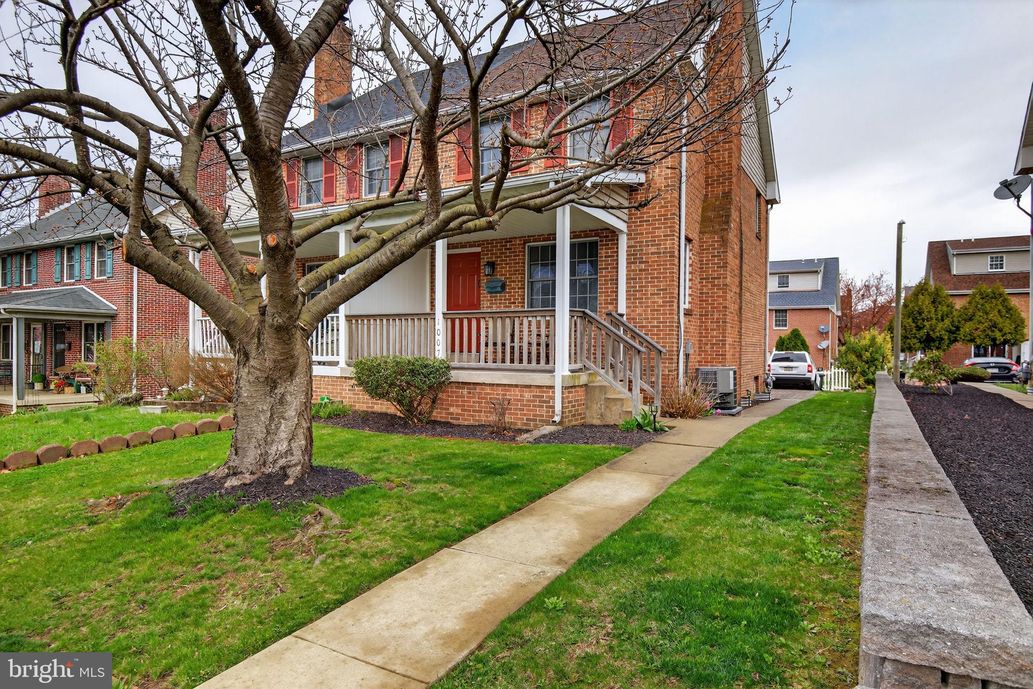 1007 East Walnut Street Lancaster, PA 17602 - Photo 3 of 35 a front view of a house with a garden and trees
