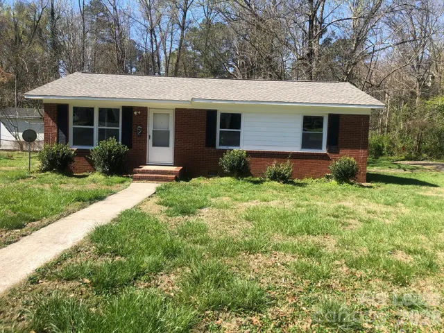 a front view of a house with garden and porch