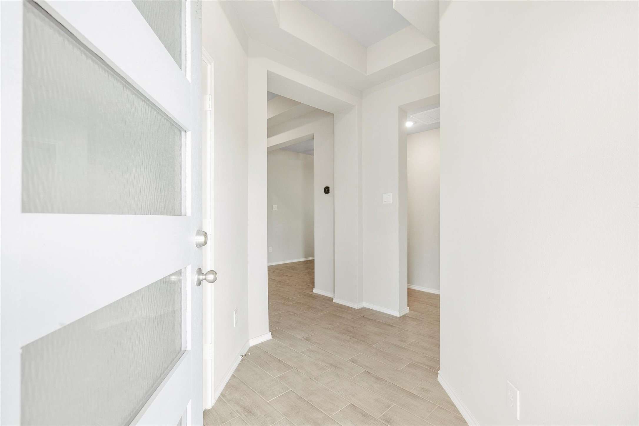 17270 Wild Watermelon Way Conroe, TX 77302 - Photo 3 of 28 The moment you walk in, the tone is set. A bright, open foyer with high ceilings and wood-look tile flooring flows naturally into the heart of the home.