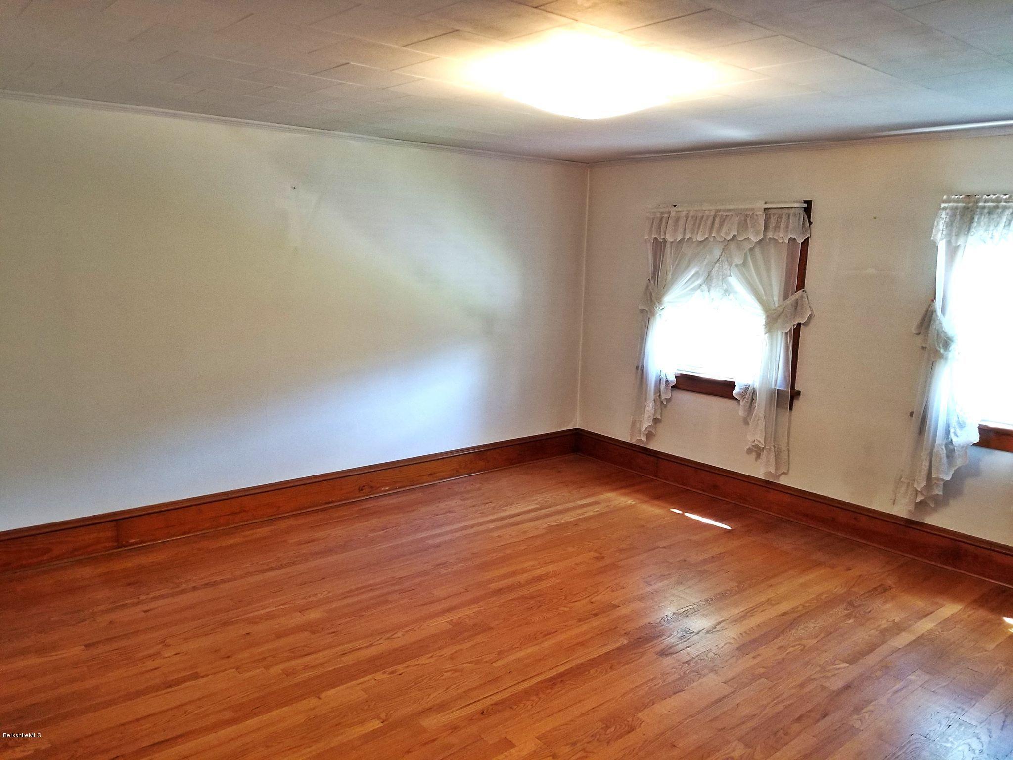 213 East Road Adams, MA 01220 - Photo 16 of 21 an empty room with wooden floor and windows