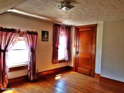 213 East Road Adams, MA 01220 - Photo 18 of 21 a view of an empty room with wooden floor and a window