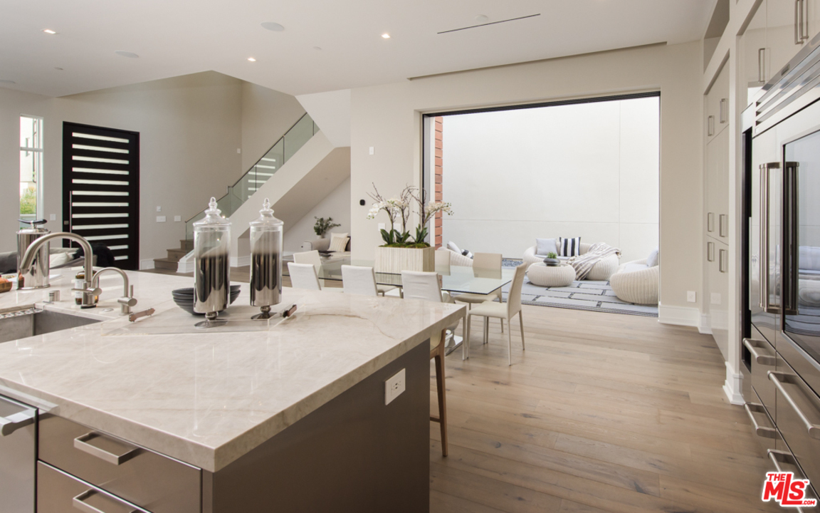 5918 Firefly Place Playa Vista, CA 90094 - Photo 11 of 34 a kitchen with kitchen island a sink table and chairs