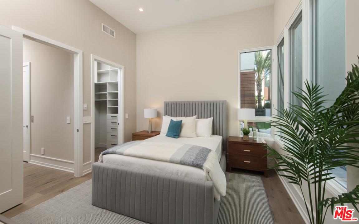 5918 Firefly Place Playa Vista, CA 90094 - Photo 13 of 34 a bedroom with a large bed and a potted plant