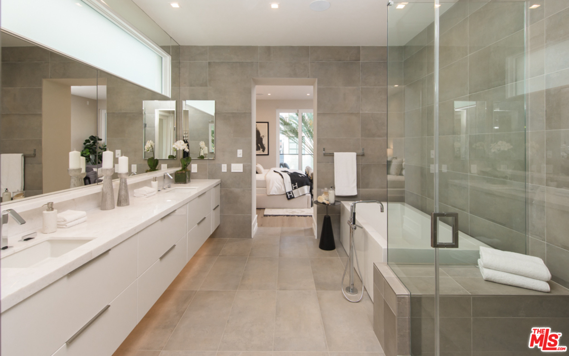5918 Firefly Place Playa Vista, CA 90094 - Photo 21 of 34 a large white bathroom with a double vanity sink a mirror and a shower