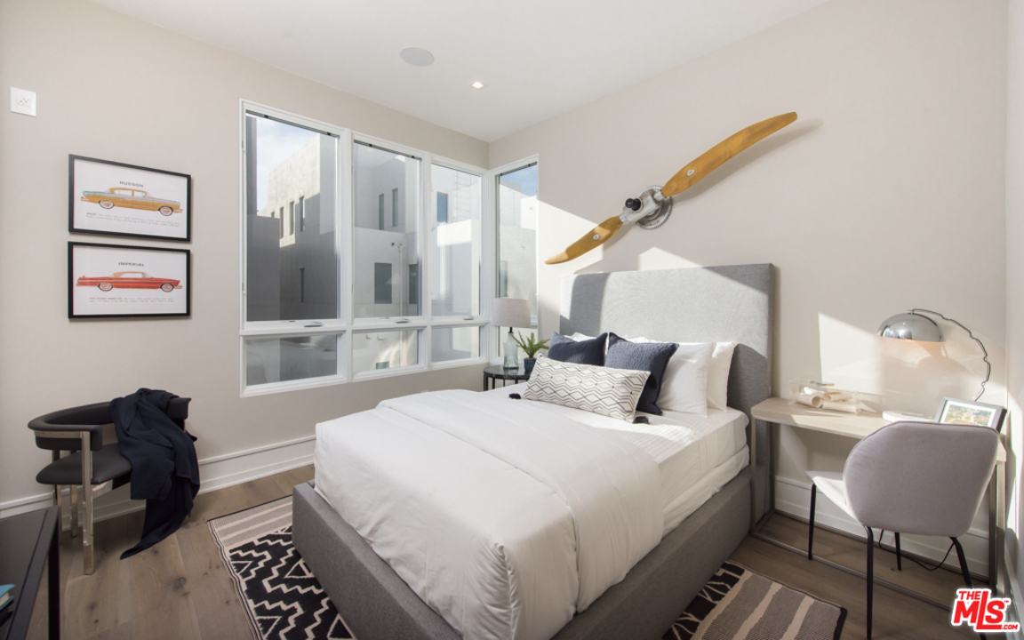 5918 Firefly Place Playa Vista, CA 90094 - Photo 24 of 34 a bedroom with a bed and a bookshelf with wooden floor