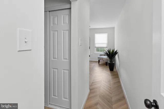 a view of a hallway with a livingroom and a livingroom
