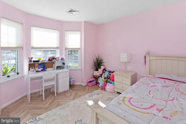 a playing room with a baby crib and a couch