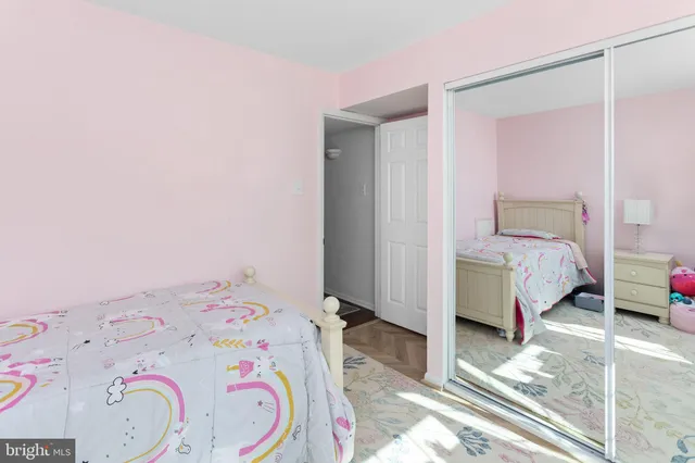 a bedroom with a bed and a white cabinet