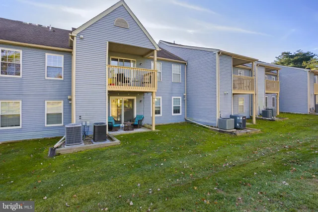 front view of a brick house with a yard