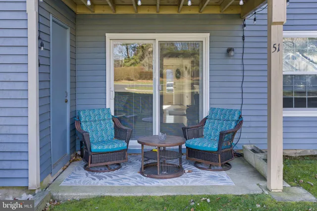 a view of two chairs in the back yard of the house