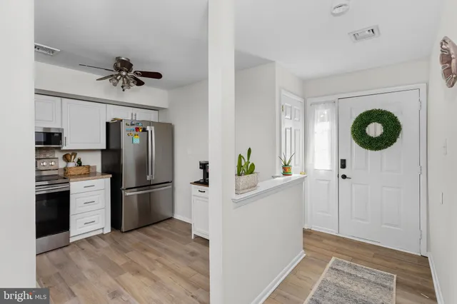 a kitchen with stainless steel appliances a refrigerator a microwave a stove and a refrigerator