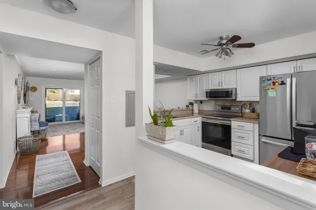 a kitchen with stainless steel appliances a stove refrigerator and microwave