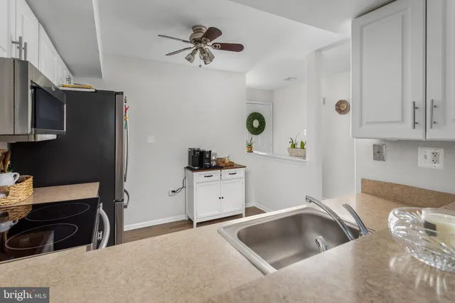 a kitchen with cabinets a sink and appliances