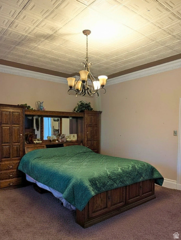 190 North 200 E Street Beaver, UT 84713 - Photo 28 of 40 Master bedroom with a recessed panel ceiling, crown molding and a multi-arm chandelier