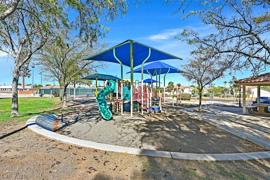 8830 Haviland Road Las Vegas, NV 89123 - Photo 32 of 43 A well-maintained neighborhood playground sits nestled beneath mature shade trees and clear blue skies.