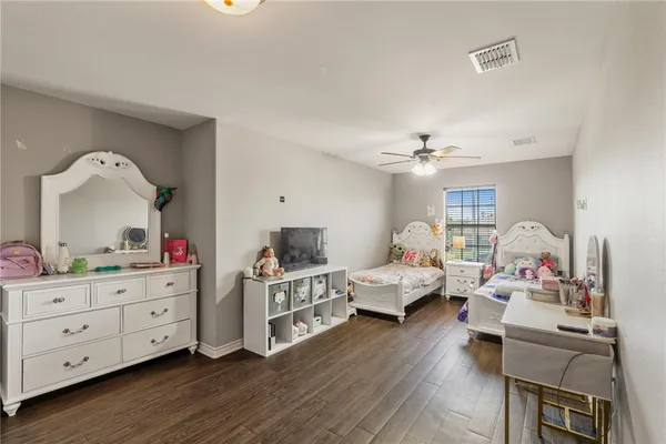 a bedroom with furniture and wooden floor