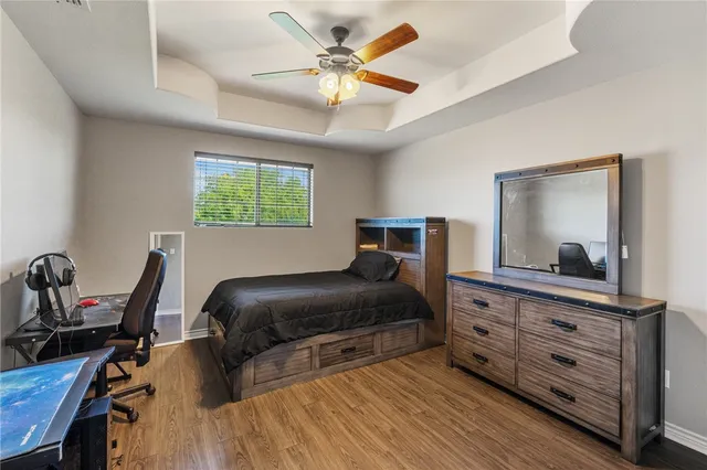 a bedroom with a bed and a dresser with mirror