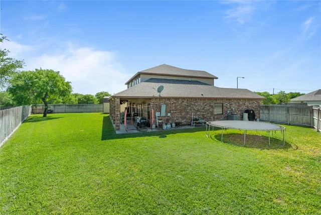 a view of a house with a yard patio and swimming pool