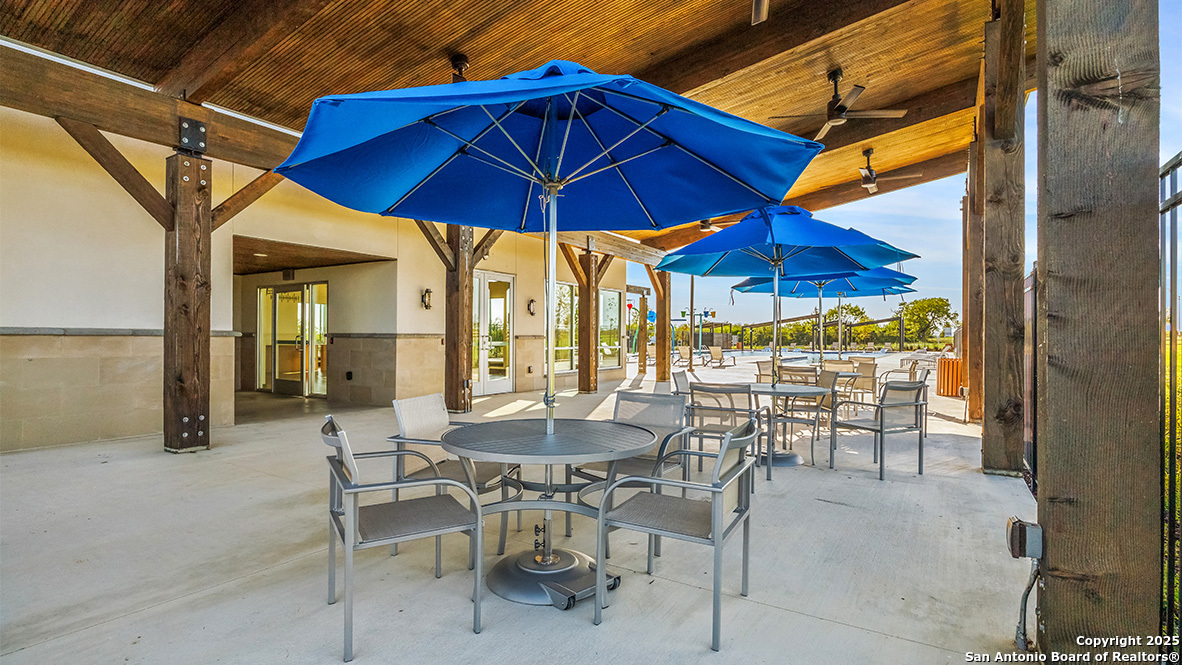 4903 Jackrabbit Converse, TX 78109 - Photo 45 of 49 a view of dining area with chairs and table under an umbrella
