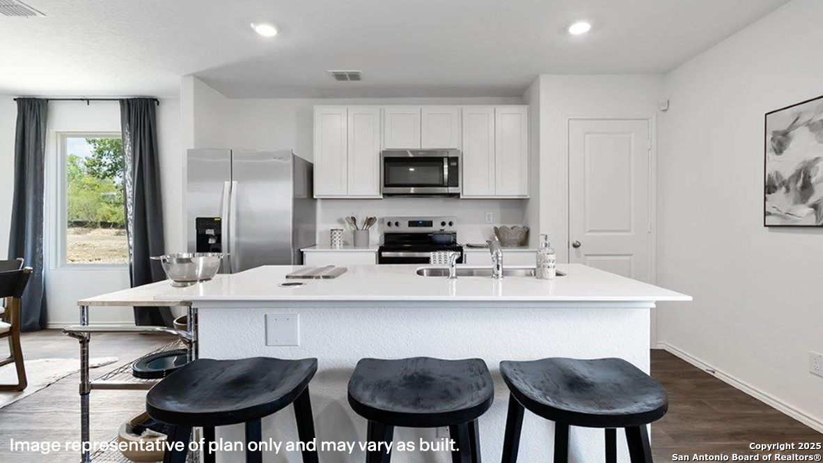 4903 Jackrabbit Converse, TX 78109 - Photo 9 of 49 a kitchen with stainless steel appliances a dining table and chairs