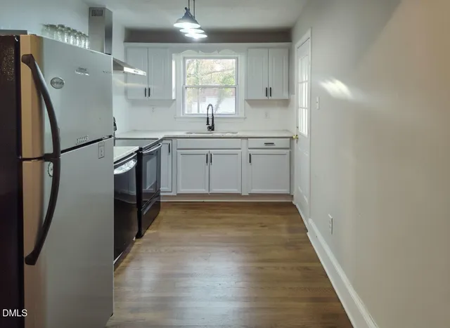 a kitchen with a refrigerator a sink and a stove