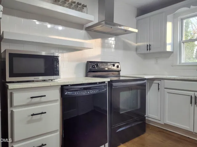 a kitchen with a stove and a microwave
