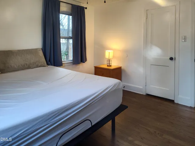 a bedroom with a bed and a lamp