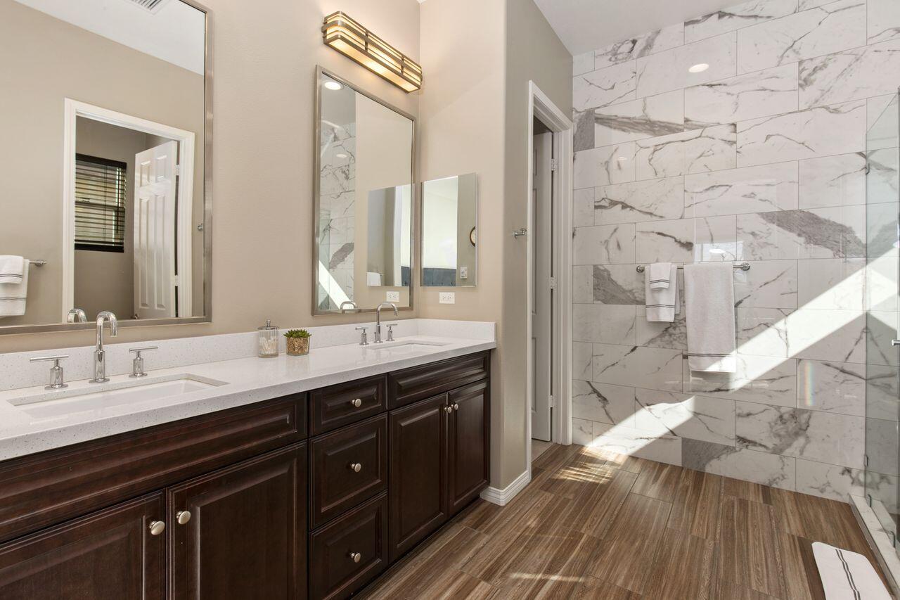 85559 Treviso Drive Indio, CA 92203 - Photo 16 of 30 a bathroom with a double vanity sink mirror and shower