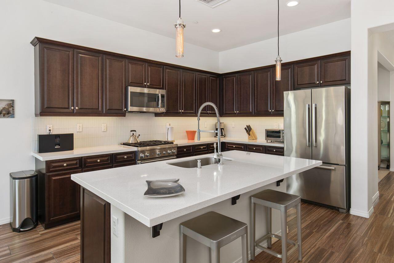 85559 Treviso Drive Indio, CA 92203 - Photo 6 of 30 a kitchen with kitchen island a sink stove and refrigerator