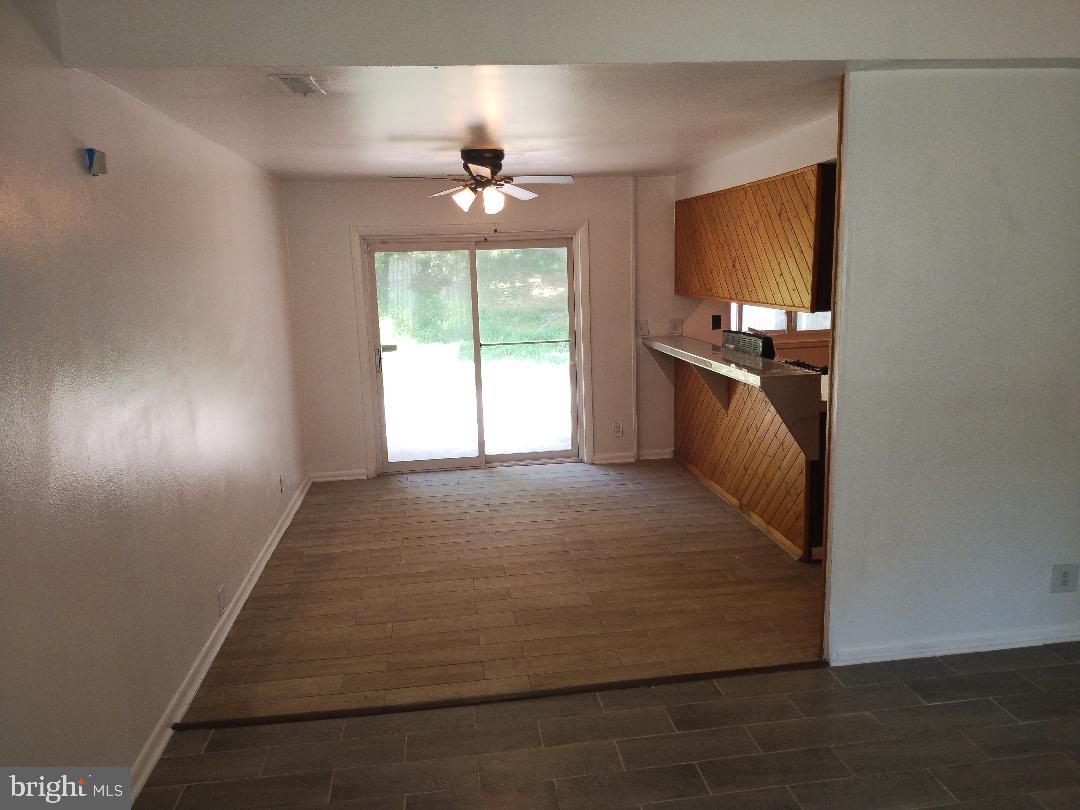 2841 Aquarius Avenue Silver Spring, MD 20906 - Photo 12 of 57 a large bedroom with a bed and a chandelier fan