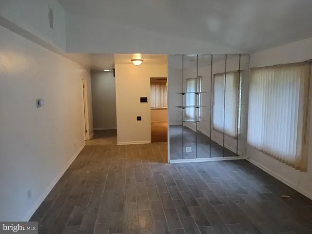 a kitchen with granite countertop a sink stove and refrigerator