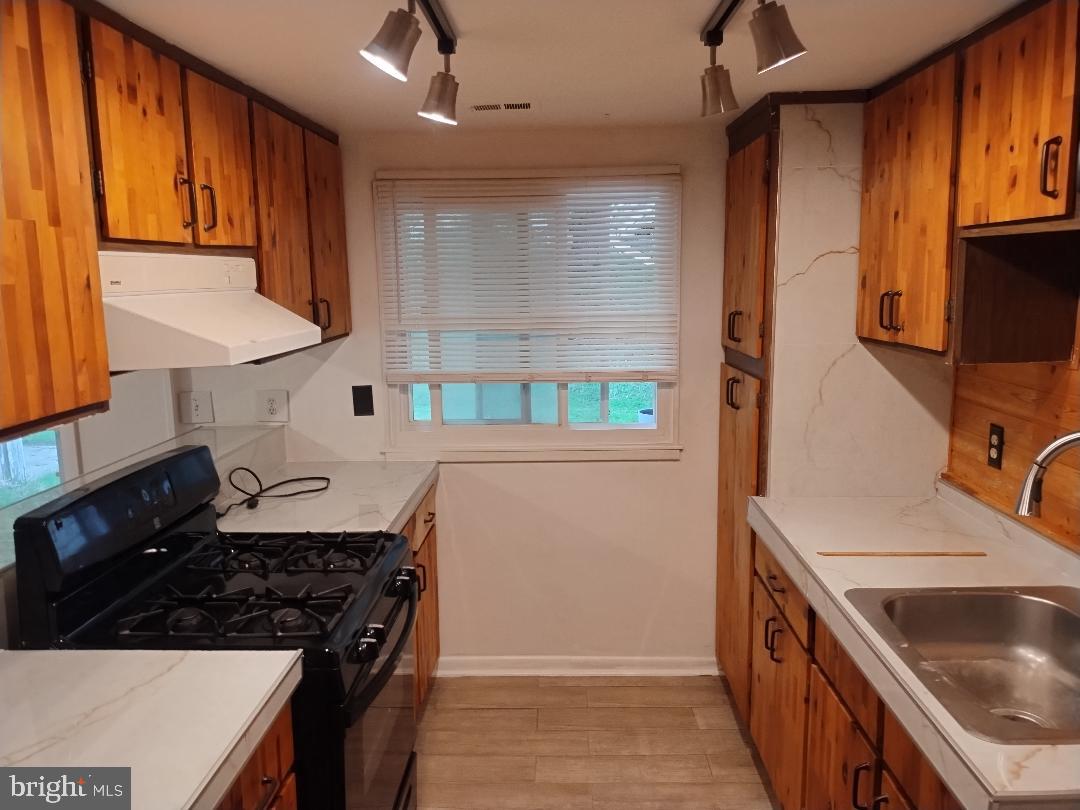 2841 Aquarius Avenue Silver Spring, MD 20906 - Photo 30 of 57 a kitchen with granite countertop a sink stove and refrigerator