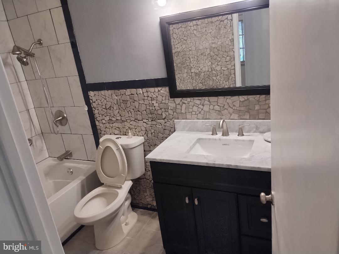 2841 Aquarius Avenue Silver Spring, MD 20906 - Photo 33 of 57 a bathroom with a sink a toilet and a mirror
