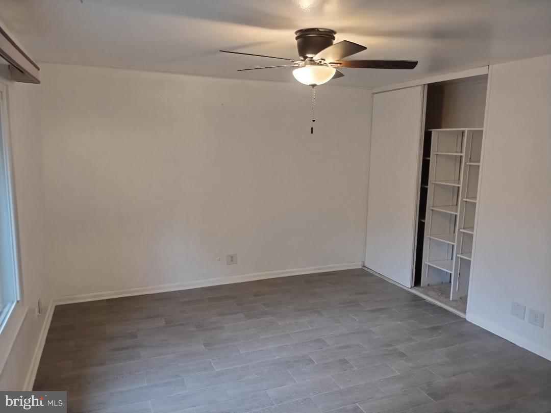 2841 Aquarius Avenue Silver Spring, MD 20906 - Photo 37 of 57 an empty room with a chandelier fan and a window