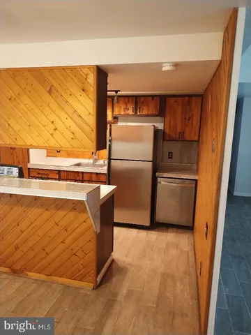 a view of kitchen with stainless steel appliances granite countertop cabinets and sink