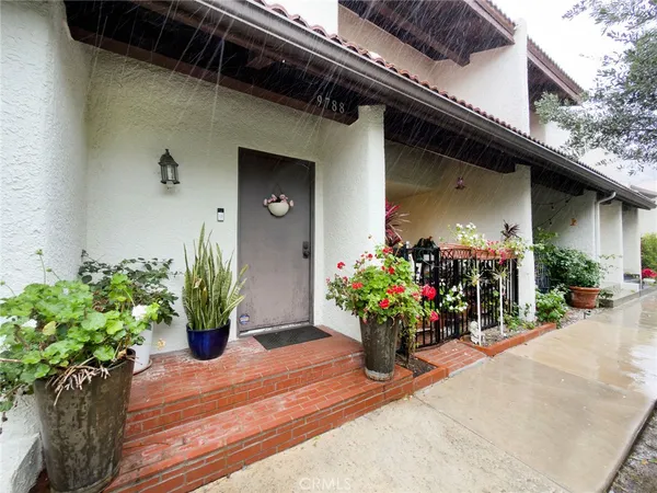a view of a house with flower pots