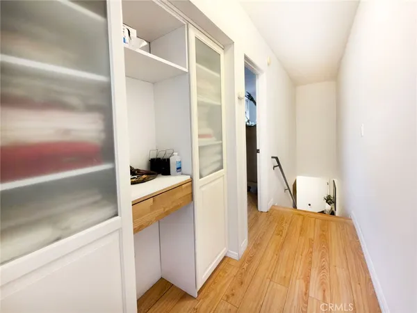a bedroom with a bed wooden floor and window