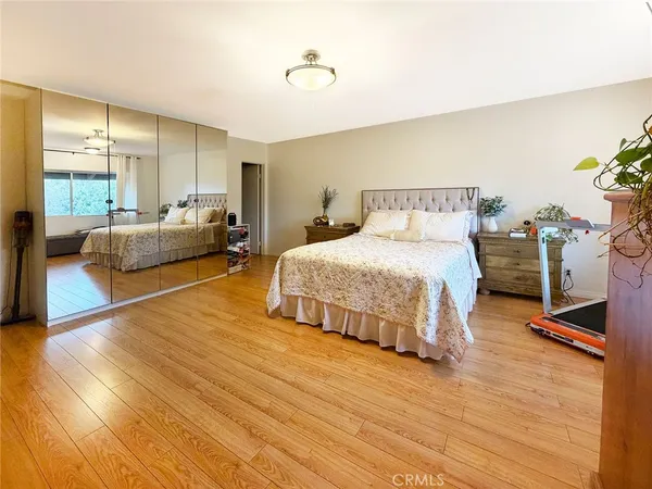 a bathroom with a granite countertop sink a toilet a mirror and shower