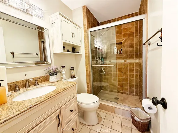 a bedroom with a bed couch and a window