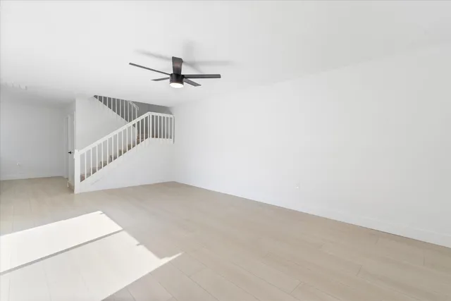 a view of a room with a ceiling fan