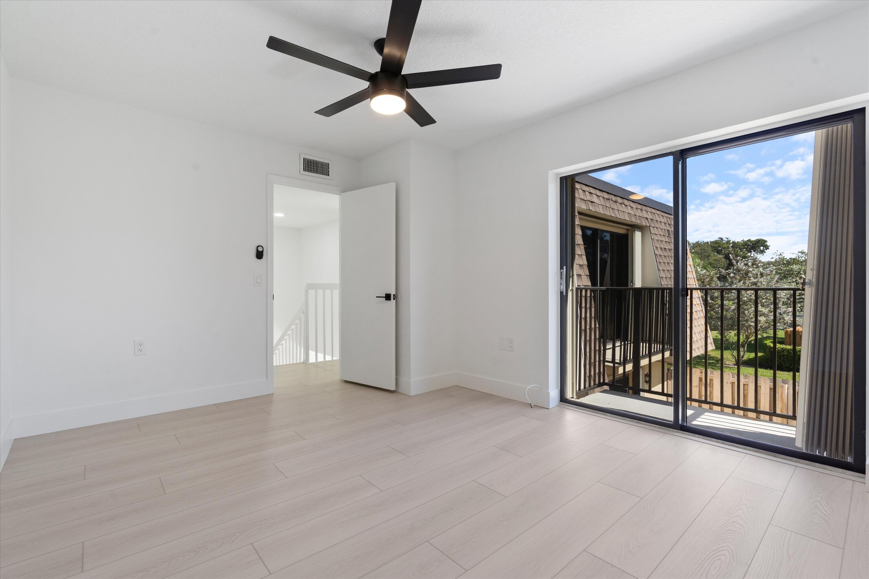 2897 Southwest 22nd Circle, Unit 44B Delray Beach, FL 33445 - Photo 19 of 31 an empty room with chandelier fan