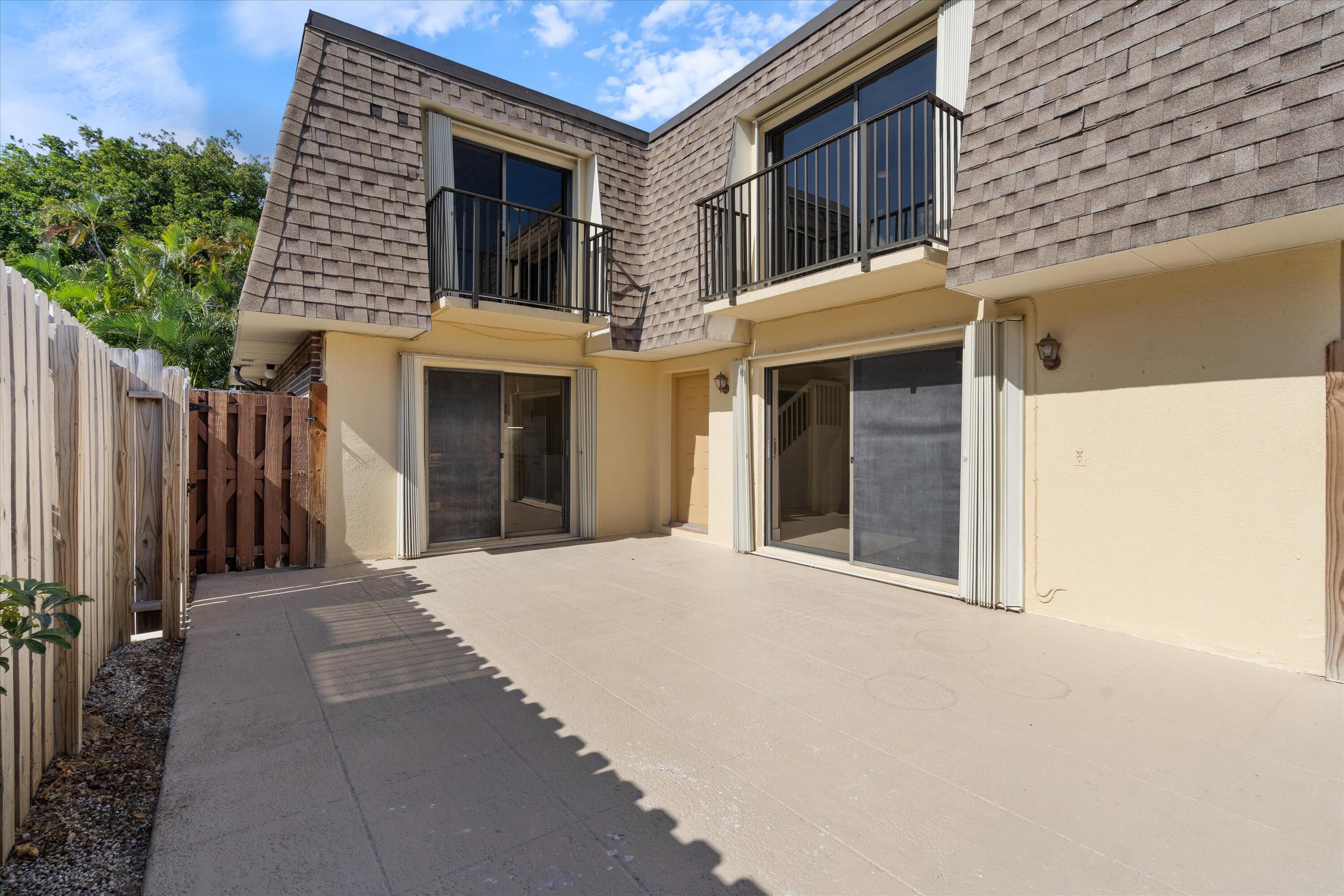 2897 Southwest 22nd Circle, Unit 44B Delray Beach, FL 33445 - Photo 2 of 31 a front view of a house with a porch