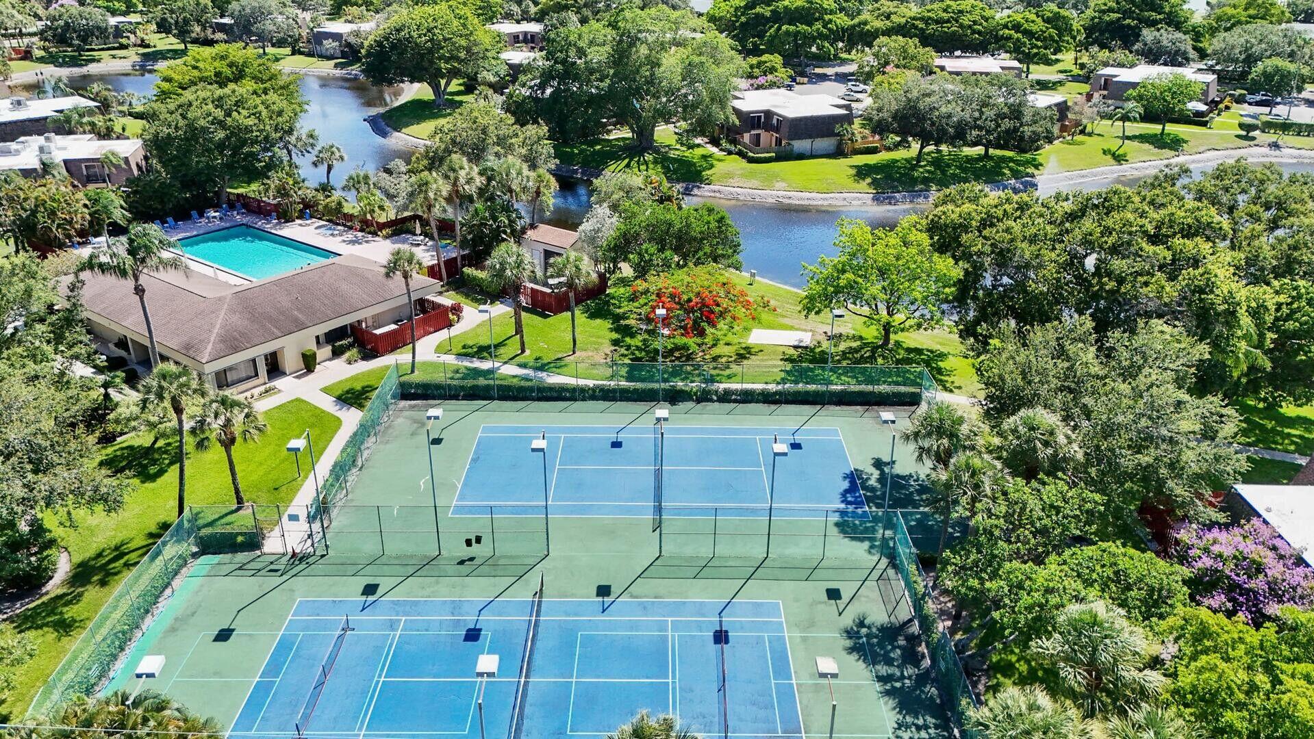 2897 Southwest 22nd Circle, Unit 44B Delray Beach, FL 33445 - Photo 30 of 31 an aerial view of a house with a yard and lake view